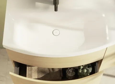 Die Nahaufnahme eines Waschtischs der Serie Sinea 3.0 mit geschwungener Form zeigt eine geöffnete Holzschublade unter einem weißen Mineralgussbecken.