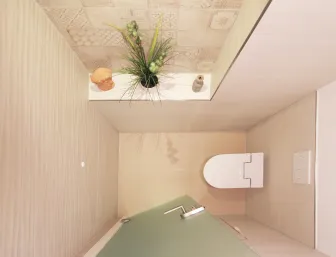 Ein kleines, modernes Badezimmer aus der Vogelperspektive mit einer kompakten Toilette und einem Waschbecken mit grünlicher Glasablage.