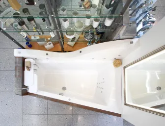 Eine Draufsicht auf eine moderne Badewanne mit schlichten, klaren Linien, die in eine minimalistische Umgebung eingebettet ist. 