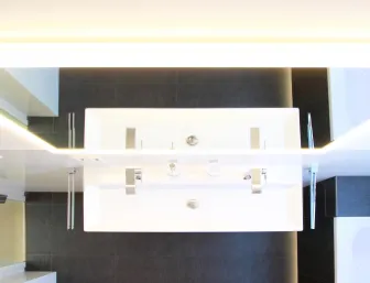 Ein modernes Doppelwaschbecken mit klaren, rechteckigen Formen und glänzenden Chromarmaturen, aufgenommen aus der Vogelperspektive.